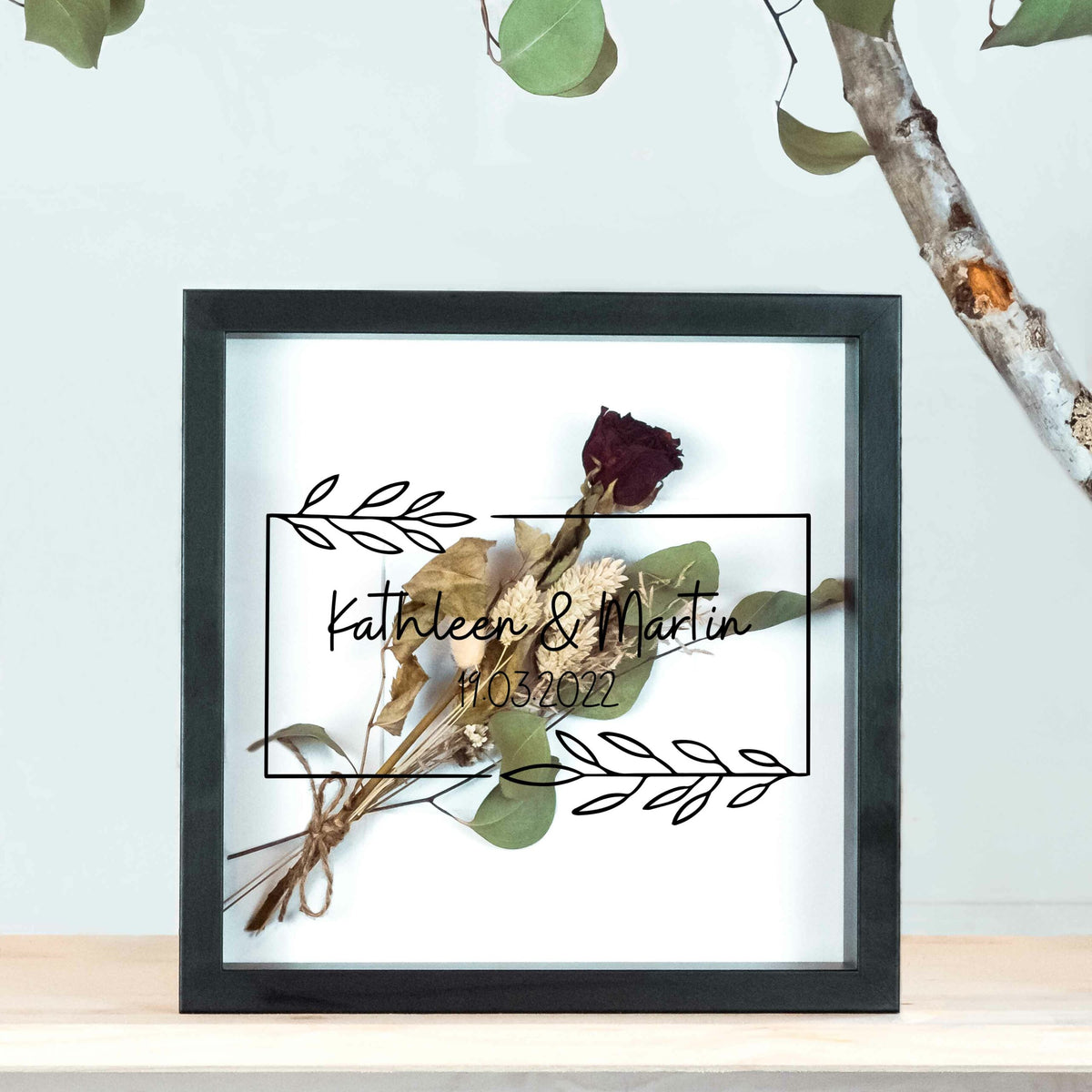 Kleiner schwarzer Brautstraußrahmen mit Blätterranke, schwarzer Schrift und Trockenblumen